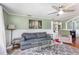 Comfortable living room with a soft gray sofa, a recliner, and a large patterned area rug at 2237 Avenue B Nw, Winter Haven, FL 33880
