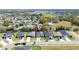 Aerial view of a neighborhood with tree-lined streets and well-maintained homes near a lake at 2461 Bulrush Dr, St Cloud, FL 34769