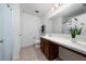 A clean bathroom with a single sink vanity, a large mirror, and a shower-tub combo at 2461 Bulrush Dr, St Cloud, FL 34769