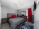 A modern bedroom featuring gray walls, carpet, and an entertainment center with a wall-mounted TV at 2461 Bulrush Dr, St Cloud, FL 34769