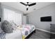 A cozy bedroom with a ceiling fan, two closets, and a brightly patterned quilt at 2461 Bulrush Dr, St Cloud, FL 34769