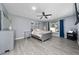 A beautifully appointed bedroom with a ceiling fan and a window with blue curtains at 2461 Bulrush Dr, St Cloud, FL 34769
