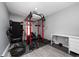 A home gym featuring a weight rack, bench, treadmill, and free weights for a complete workout experience at 2461 Bulrush Dr, St Cloud, FL 34769