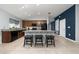 Kitchen features a granite island with seating, tile flooring, and stainless steel appliances at 2461 Bulrush Dr, St Cloud, FL 34769