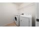 The laundry room features modern washer and dryer units and a wire shelf for storage at 2461 Bulrush Dr, St Cloud, FL 34769