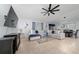 Cozy living room featuring a plush sectional sofa, large TV, ceiling fan, and plenty of natural light at 2461 Bulrush Dr, St Cloud, FL 34769