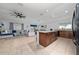 Open-concept kitchen seamlessly flows into the living room area with tile flooring and natural light at 2461 Bulrush Dr, St Cloud, FL 34769