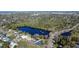 Wide aerial view of a neighborhood with a lake, trees and single-Gathering homes at 2654 Derbyshire Rd, Maitland, FL 32751