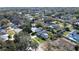 Wide aerial view of a neighborhood featuring mature trees, landscaping, and a red balloon at 2654 Derbyshire Rd, Maitland, FL 32751