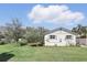 Well-maintained backyard featuring a lush lawn and mature trees at 2654 Derbyshire Rd, Maitland, FL 32751