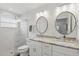 Modern bathroom with dual sinks, marble countertops, and glass-enclosed shower at 2654 Derbyshire Rd, Maitland, FL 32751