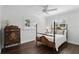 Bright bedroom with wood floors, a four-poster bed, and plantation shutters allowing natural light at 2654 Derbyshire Rd, Maitland, FL 32751