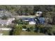 Aerial view of a white home with a dark roof and a well maintained green lawn at 2654 Derbyshire Rd, Maitland, FL 32751