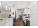 Bright kitchen featuring marble countertops, stainless steel appliances, and hardwood floors at 2654 Derbyshire Rd, Maitland, FL 32751
