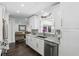 Bright kitchen featuring marble countertops, stainless steel appliances, and hardwood floors at 2654 Derbyshire Rd, Maitland, FL 32751