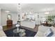 Open living space with hardwood floors connecting the living room, kitchen, and dining area at 2654 Derbyshire Rd, Maitland, FL 32751