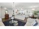 Comfortable open-plan living space with a marble island, chandeliers, and a modern decor at 2654 Derbyshire Rd, Maitland, FL 32751