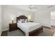 Comfortable main bedroom featuring a ceiling fan, matching nightstands, and ensuite bathroom access at 2654 Derbyshire Rd, Maitland, FL 32751