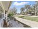 Charming front porch featuring a brick wall and comfortable outdoor seating with a view at 2654 Derbyshire Rd, Maitland, FL 32751