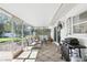 Relaxing screened-in porch with a grill, comfortable seating, and outdoor views at 2654 Derbyshire Rd, Maitland, FL 32751