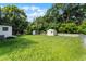 Green backyard with trees and exterior view of the home at 2816 S French Ave, Sanford, FL 32773