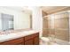 Bathroom with double vanity and a glass-enclosed shower at 2851 Sunstone Dr # 2851, Kissimmee, FL 34758