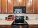 Close up of a kitchen featuring granite counters, stainless steel appliances, and wooden cabinetry at 2941 Marlberry Ln, Clermont, FL 34714