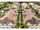 Aerial view of townhouse community featuring lush landscaping, well-maintained roofs, and uniform architectural design at 2962 Lucayan Harbour Cir # 102, Kissimmee, FL 34746