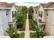 Aerial view of townhome community featuring landscaped walkways, lush greenery, and well-maintained exteriors at 2962 Lucayan Harbour Cir # 102, Kissimmee, FL 34746