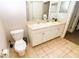 Clean bathroom featuring a double vanity, a toilet, and tile floors at 2962 Lucayan Harbour Cir # 102, Kissimmee, FL 34746