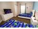 Charming bedroom showcasing two twin beds, a dresser with a TV, and playful Toy Story-themed decor at 2962 Lucayan Harbour Cir # 102, Kissimmee, FL 34746