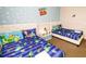 Themed bedroom with two beds featuring Toy Story bedding and a fun cloud-themed mural at 2962 Lucayan Harbour Cir # 102, Kissimmee, FL 34746