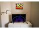A bedroom with a Toy Story sign above a dresser and TV, creating a fun and engaging space at 2962 Lucayan Harbour Cir # 102, Kissimmee, FL 34746