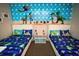 Themed bedroom with two beds featuring colorful Toy Story bedding and a vibrant character mural at 2962 Lucayan Harbour Cir # 102, Kissimmee, FL 34746