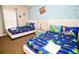 Charming bedroom with two beds featuring Toy Story bedding and a playful cloud and character mural at 2962 Lucayan Harbour Cir # 102, Kissimmee, FL 34746
