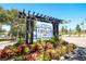 Elegant community entrance sign amidst lush landscaping, creating a welcoming and sophisticated first impression at 2962 Lucayan Harbour Cir # 102, Kissimmee, FL 34746