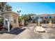 Community entrance gate with security features and signage, surrounded by well-maintained landscaping and shrubbery at 2962 Lucayan Harbour Cir # 102, Kissimmee, FL 34746