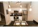 Modern kitchen with stainless steel appliances, granite countertops, and stylish pendant lighting at 2962 Lucayan Harbour Cir # 102, Kissimmee, FL 34746