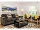 Comfortable living room featuring a plush sofa, stylish rug, and natural light from a large window at 2962 Lucayan Harbour Cir # 102, Kissimmee, FL 34746