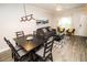 Open concept living room and dining area with modern lighting and comfortable seating at 2962 Lucayan Harbour Cir # 102, Kissimmee, FL 34746