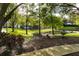 Community park with benches, tables, and a BBQ grill near a pond, lined with lush landscaping at 2962 Lucayan Harbour Cir # 102, Kissimmee, FL 34746