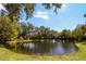 Scenic community pond with fountain surrounded by mature trees and lush landscaping at 2962 Lucayan Harbour Cir # 102, Kissimmee, FL 34746