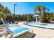 A pool area with several lounge chairs lined up next to a pool at 2962 Lucayan Harbour Cir # 102, Kissimmee, FL 34746