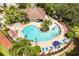 Aerial view of a community pool, hot tub, lounge chairs, and lush landscaping at 2962 Lucayan Harbour Cir # 102, Kissimmee, FL 34746