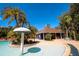Exterior of a clubhouse by a pool featuring a mushroom fountain and palm trees at 2962 Lucayan Harbour Cir # 102, Kissimmee, FL 34746