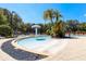 Community kiddie pool with mushroom water feature, lounge chairs, and lush landscaping provides a relaxing atmosphere at 2962 Lucayan Harbour Cir # 102, Kissimmee, FL 34746