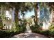 Landscaped walkway through townhome community lined with palm trees and lush foliage creates a tranquil and inviting atmosphere at 2962 Lucayan Harbour Cir # 102, Kissimmee, FL 34746
