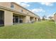 Spacious, well-maintained backyard with a view of multiple units and lush green grass at 3008 Thornton Dr, Kissimmee, FL 34741