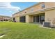 Manicured backyard with a covered patio perfect for relaxation, plus lush green grass at 3008 Thornton Dr, Kissimmee, FL 34741