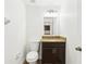 Half bathroom featuring vanity with granite counters and dark wood cabinets at 3008 Thornton Dr, Kissimmee, FL 34741